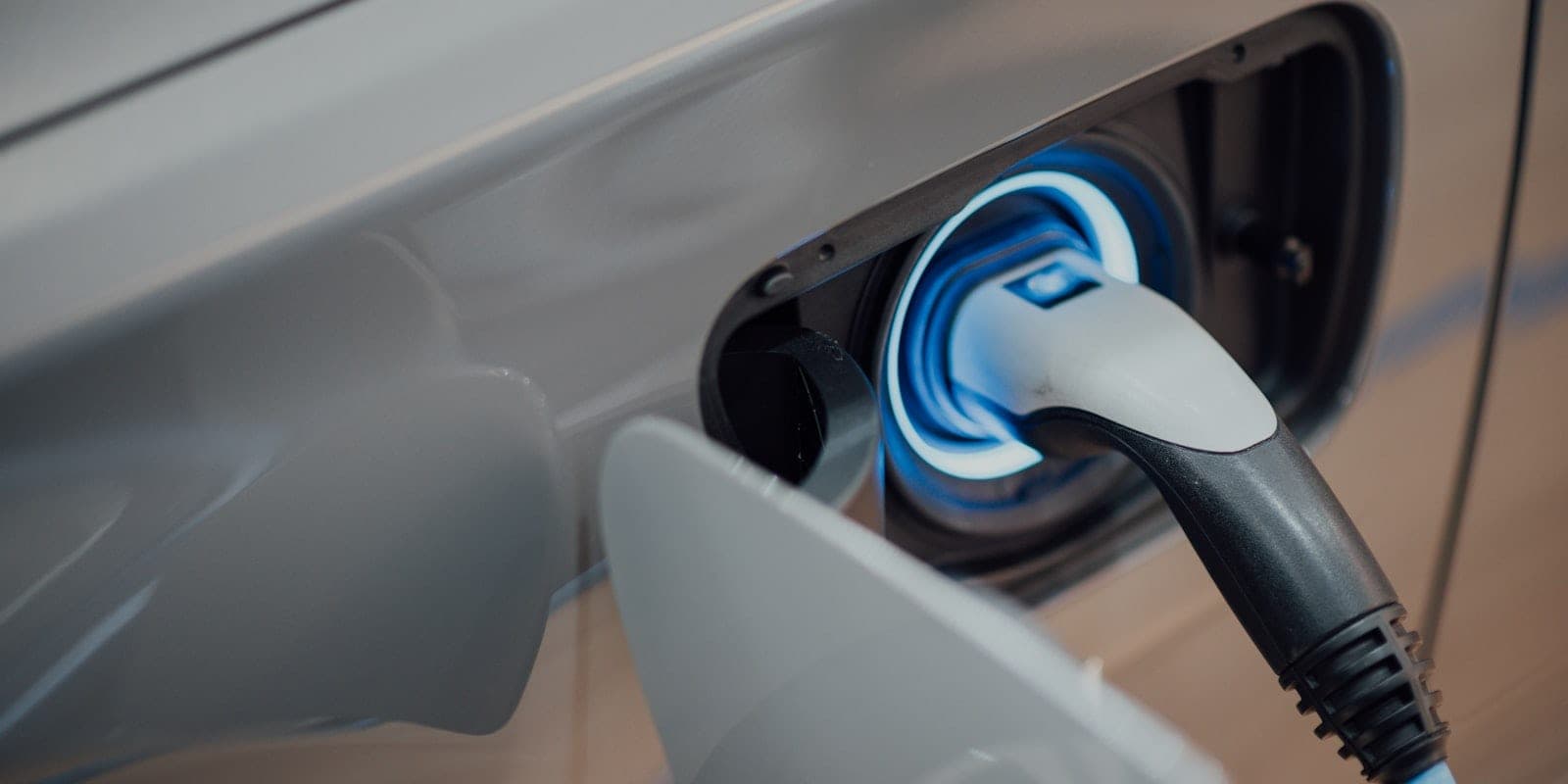 Close-up of an electric vehicle charging cable connected to a car