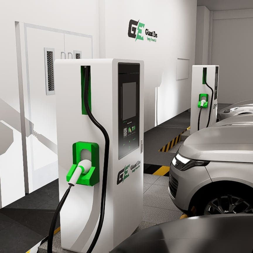 Two Giant Evs fast chargers in an indoor bay, cables connected to parked cars